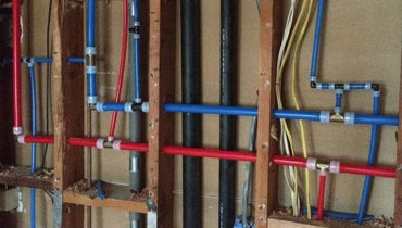 A bunch of pipes that are hanging in the wall