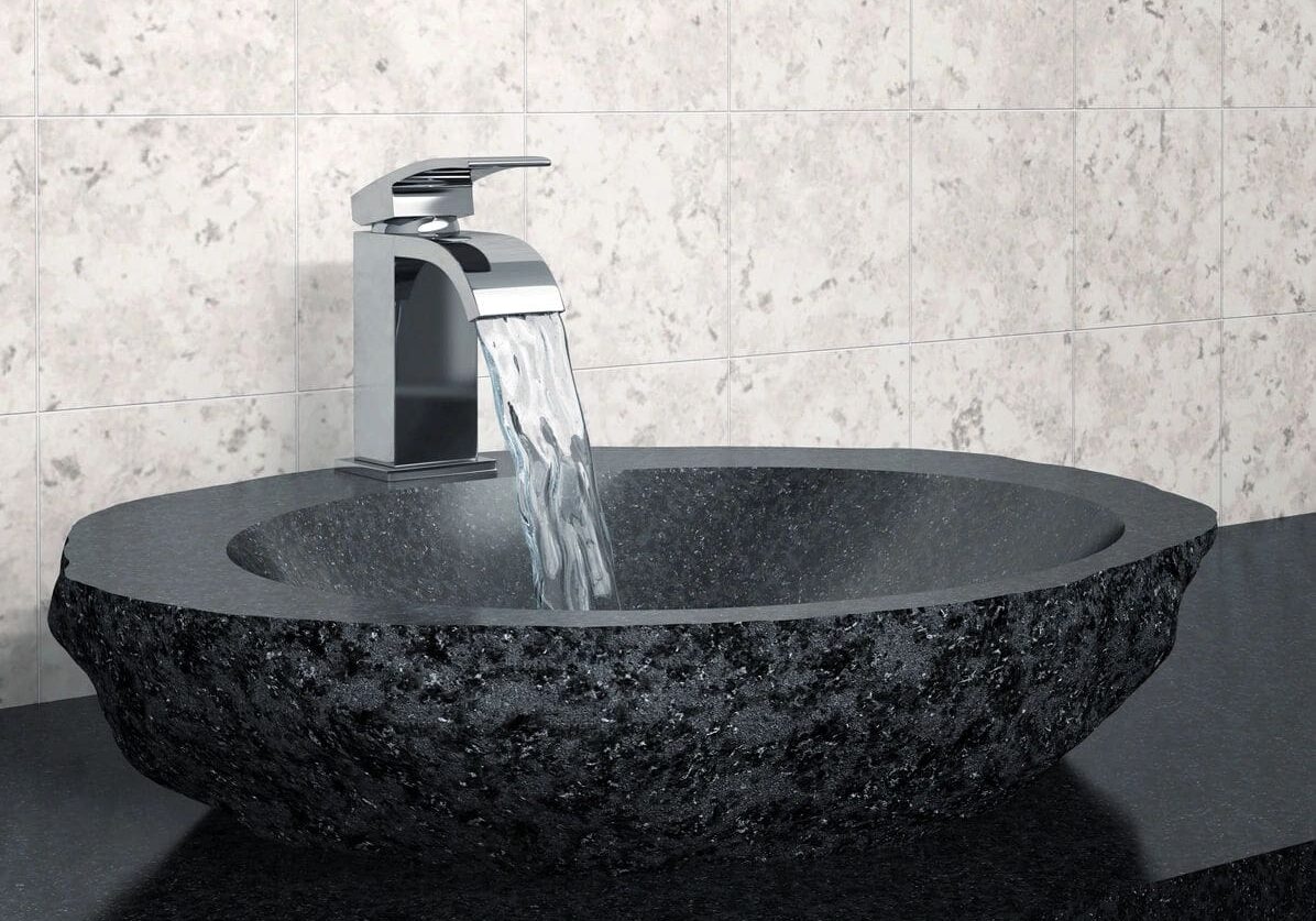 A black granite sink with a chrome faucet.